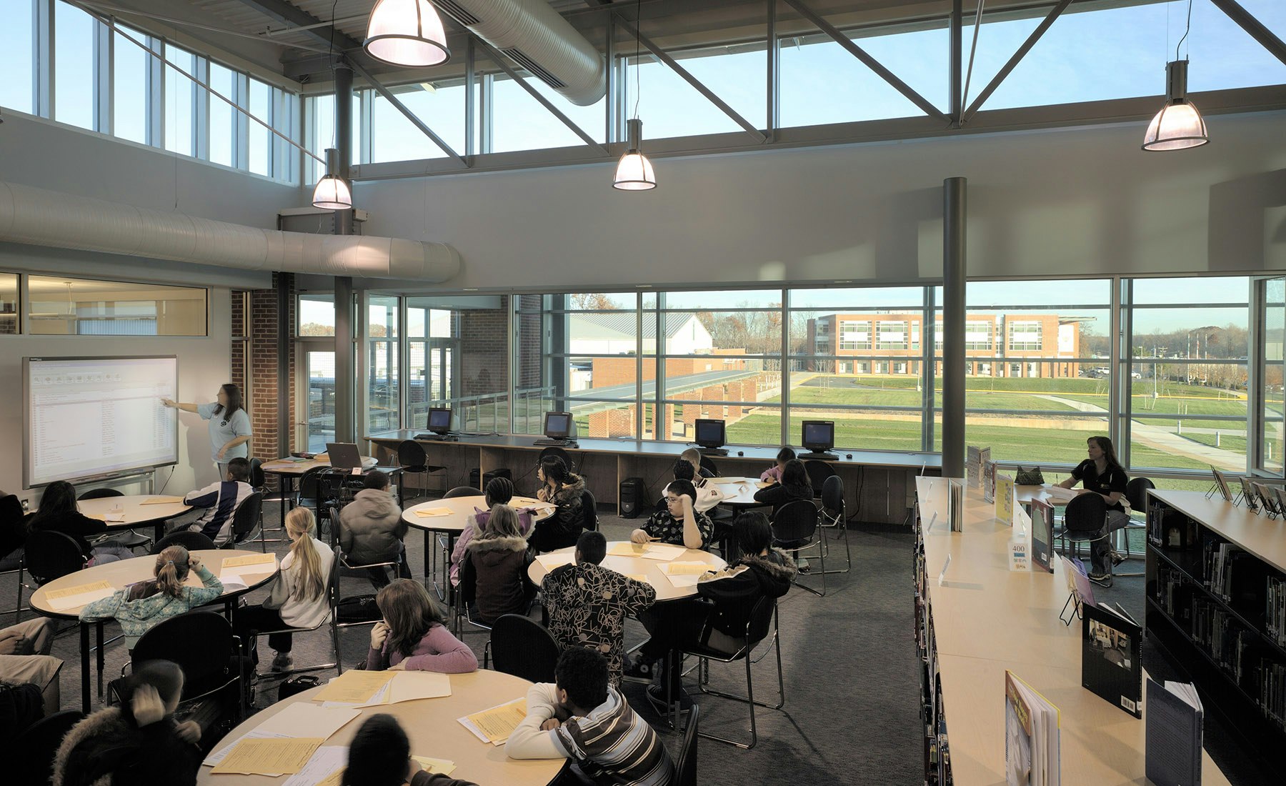 It adheres to an existing master plan that called for the new school to frame a public lawn on a shared middle / high school campus. The middle school had to remain operational throughout construction, so the project was completed in four phases. 
